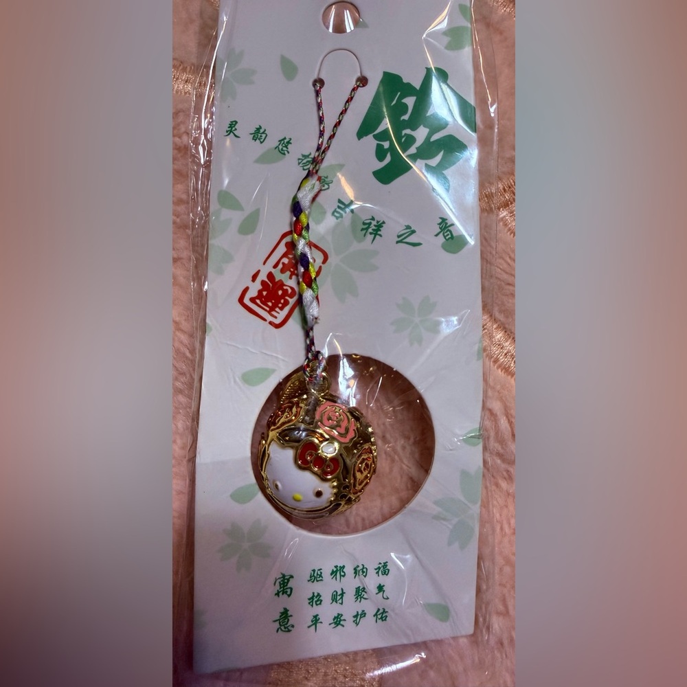 New Hello Kitty Gold Round Bell Charm features delightful sakura design 💖